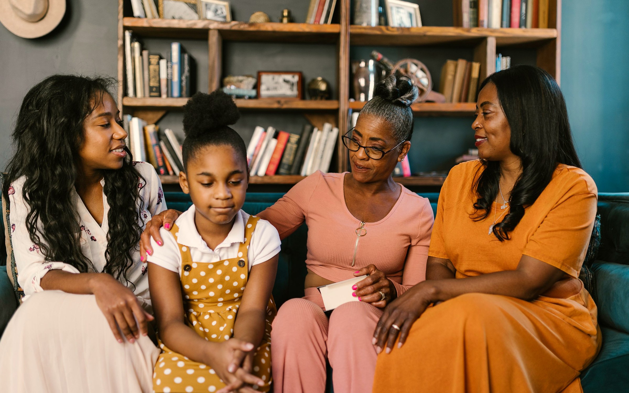 Three generations of a family talking together at home, going over paperwork